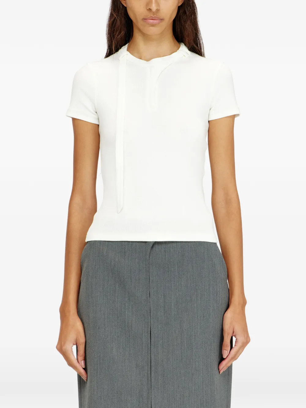 White top worn by a person, showing the top's fit