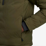 Green jacket worn by a person, showing the jacket fit