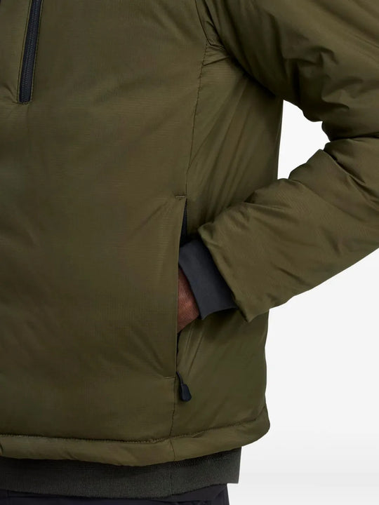 Green jacket worn by a person, showing the jacket fit
