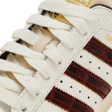 Close up of tan sneakers, showing texture of the textile and leather and rubber fabric