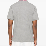 Grey shirt worn by a person, showing the shirt's fit