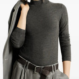 Grey knitwear worn by a person, showing the knitwear fit