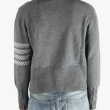 Grey knitwear worn by a person, showing the knitwear fit