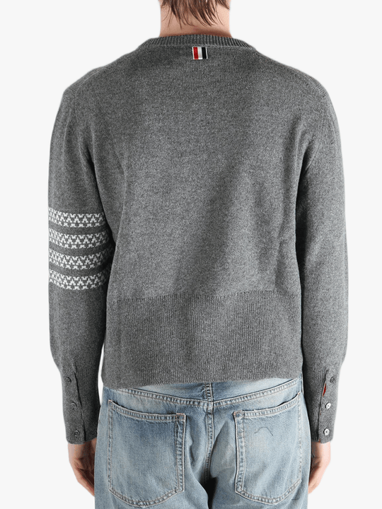 Grey knitwear worn by a person, showing the knitwear fit