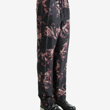 Black pants worn by a person, showing the pants' fit