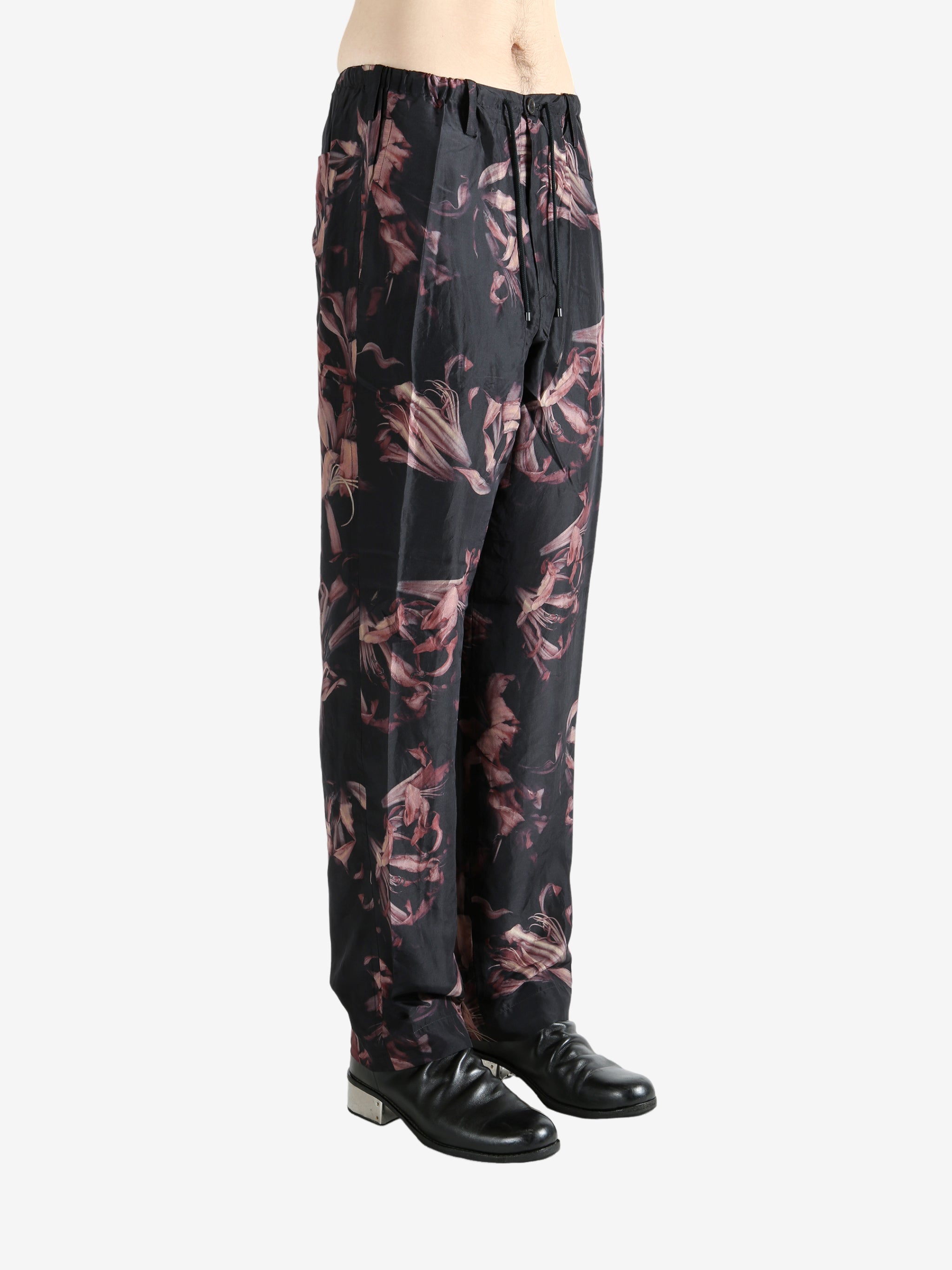 Black pants worn by a person, showing the pants' fit