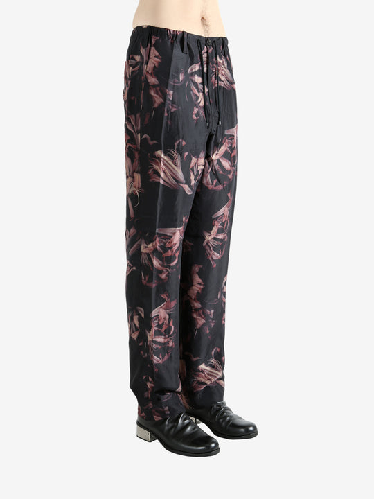 Black pants worn by a person, showing the pants' fit