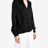 Black shirt worn by a person, showing the shirt fit