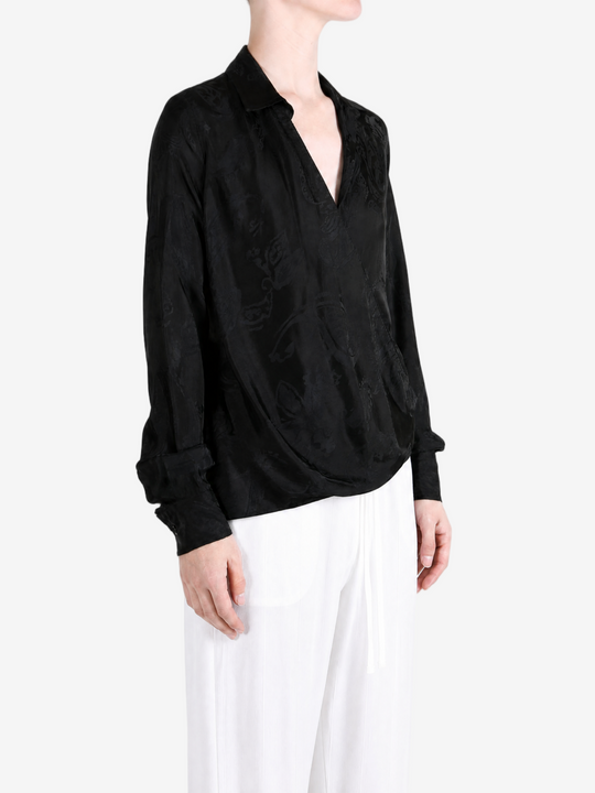 Black shirt worn by a person, showing the shirt fit