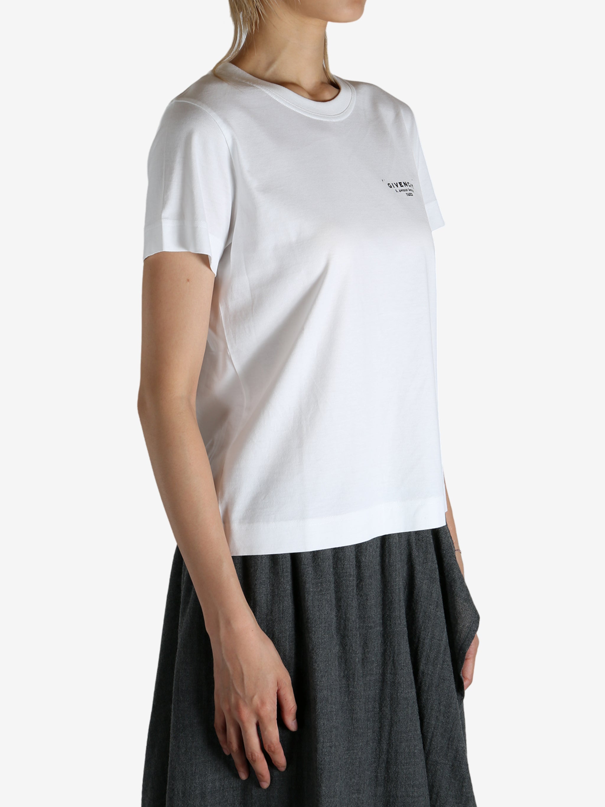 White t-shirt worn by a person, showing the shirt's fit