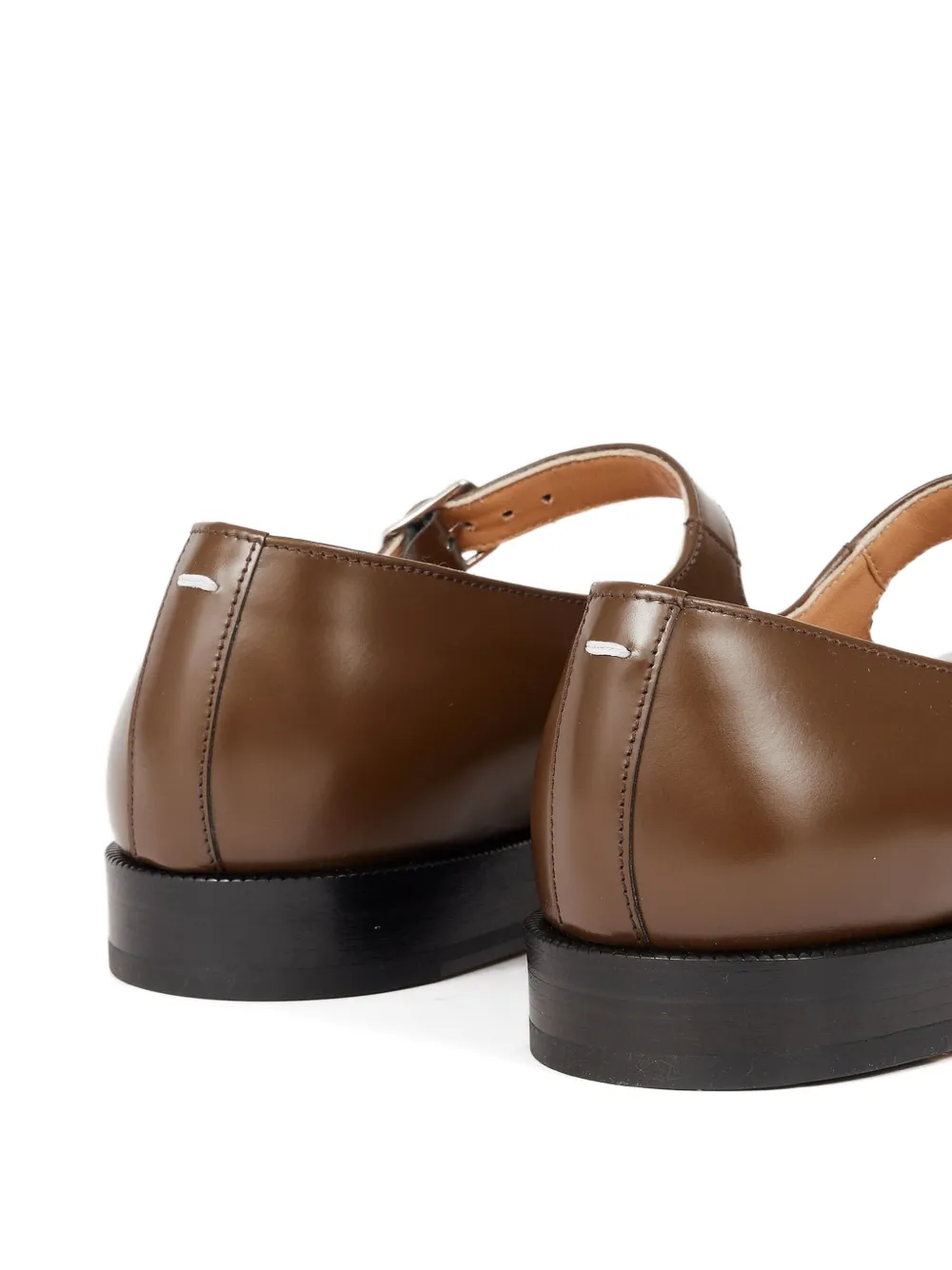 Close up of the brown shoes, showing texture of the leather fabric