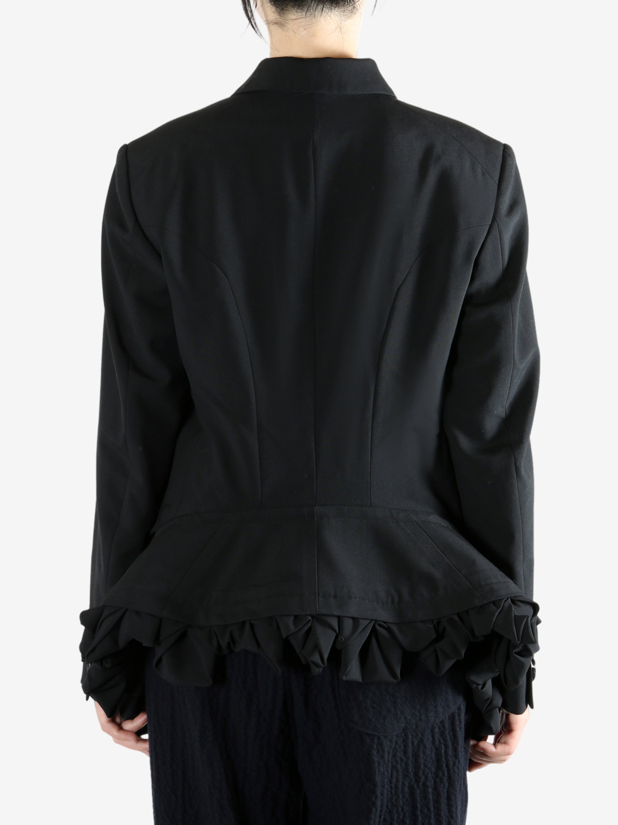 Black jacket worn by a person, showing the jacket fit