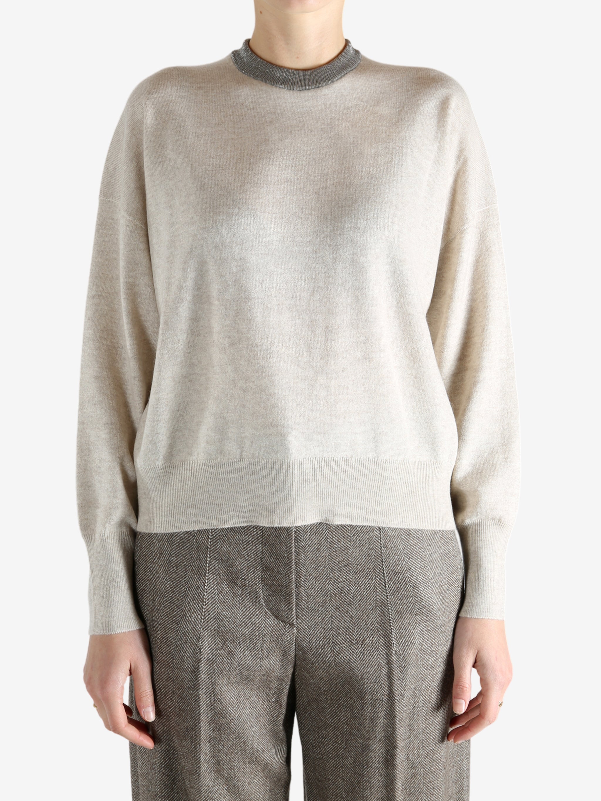 Grey knitwear worn by a person, showing the knitwear fit