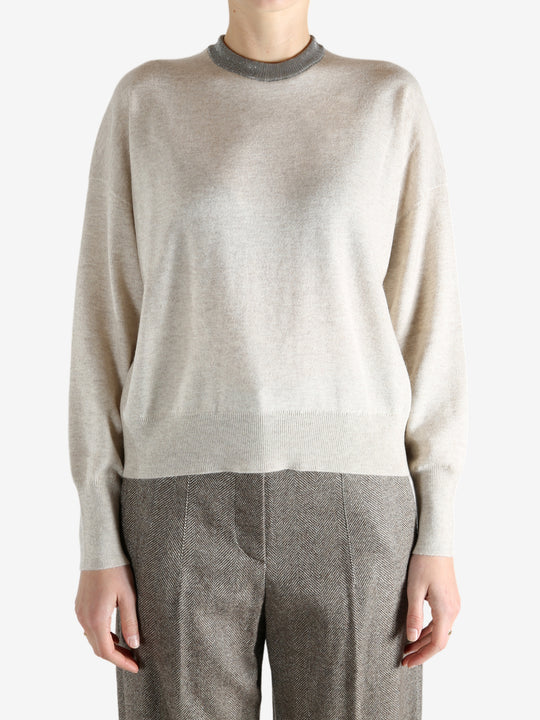 Grey knitwear worn by a person, showing the knitwear fit