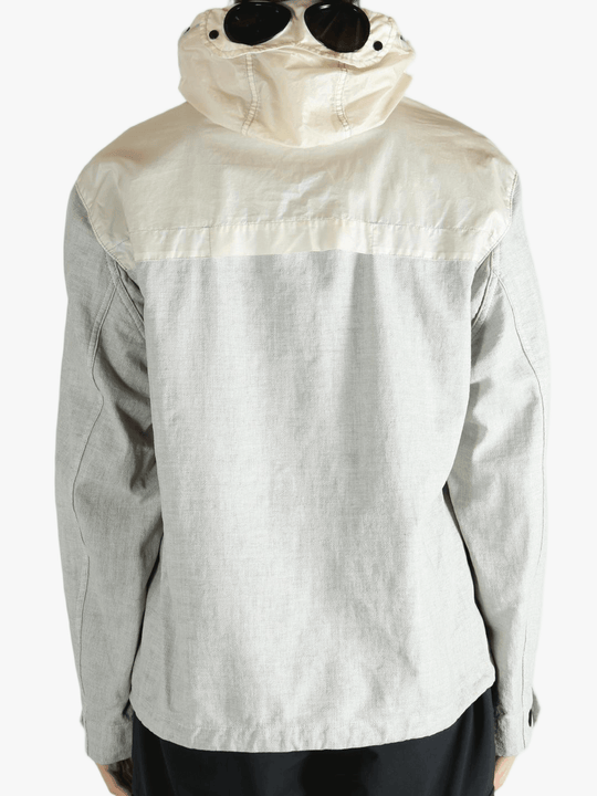 Light gray jacket worn by a person, showing the jacket fit