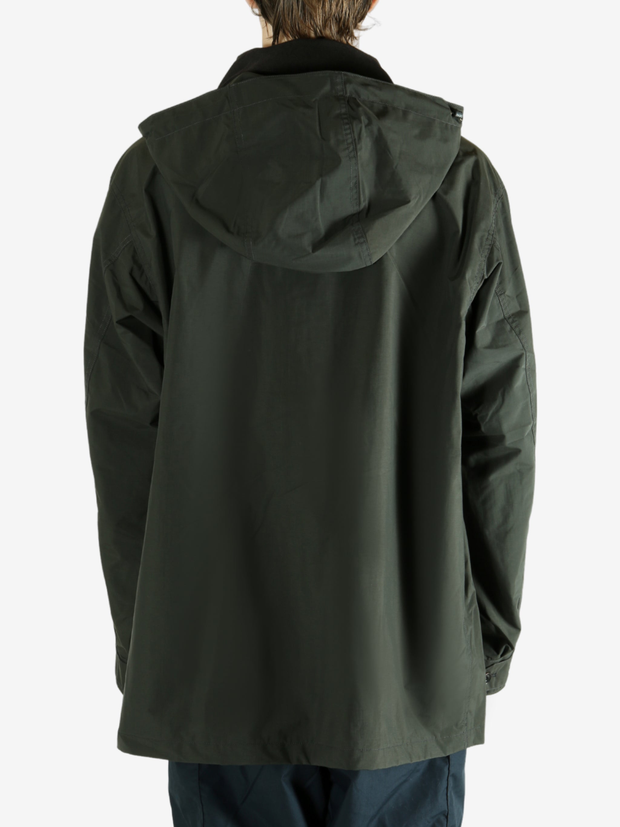 Green jacket worn by a person, showing the jacket's fit