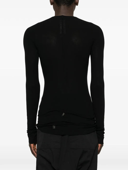 Black t-shirts worn by a person, showing the t-shirts fit