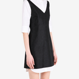 Black dress worn by a person, showing the dress fit