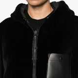 Close up of the black jacket, showing texture of the lamb fur fabric