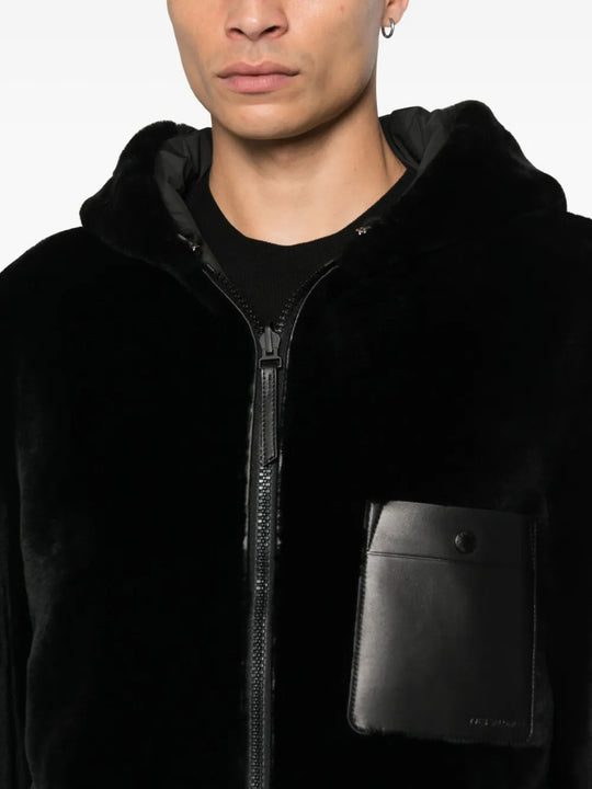 Close up of the black jacket, showing texture of the lamb fur fabric