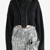 Black coats worn by a person, showing the coats fit