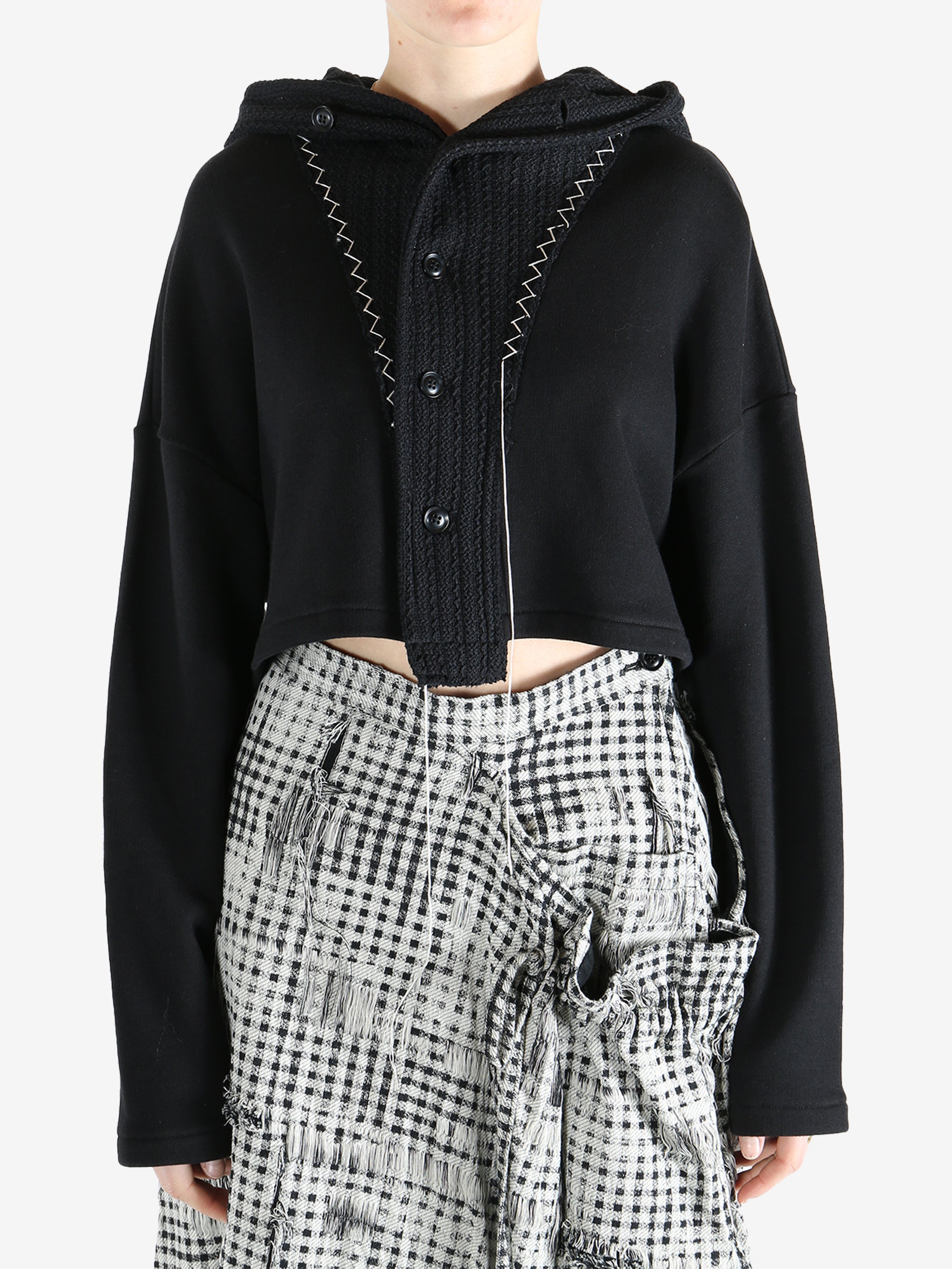 Black coats worn by a person, showing the coats fit