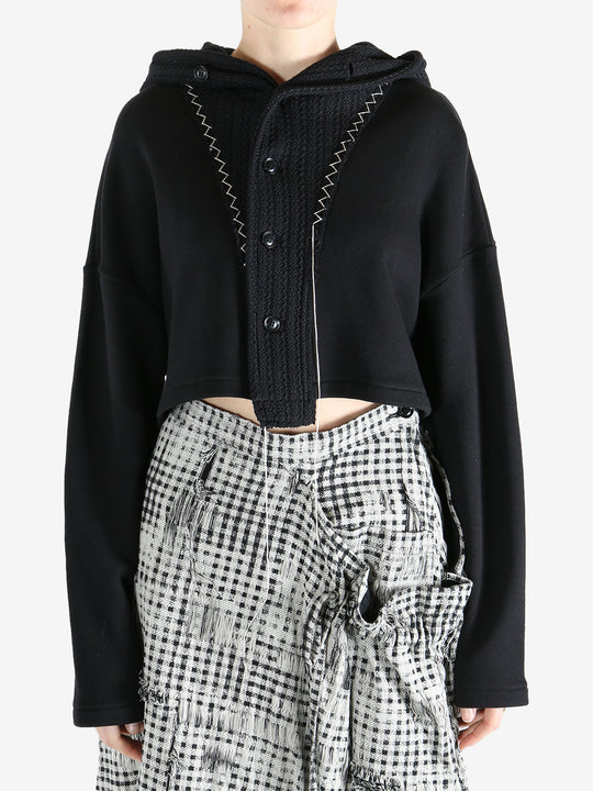 Black coats worn by a person, showing the coats fit