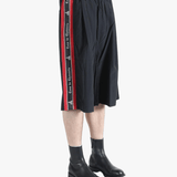 Black short worn by a person, showing the short's fit