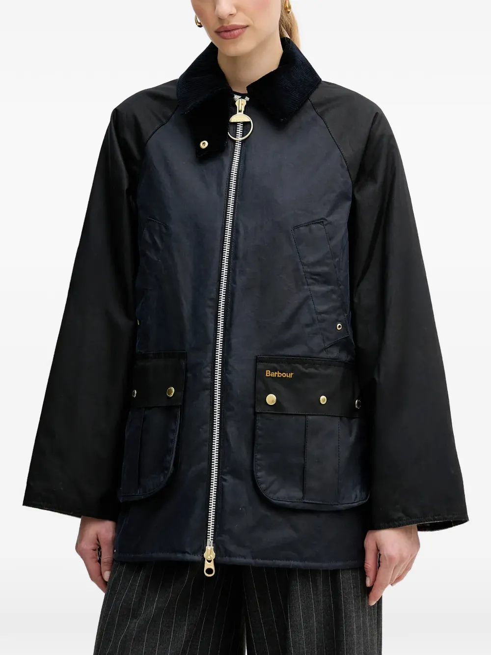 Black jacket worn by a person, showing the jacket fit