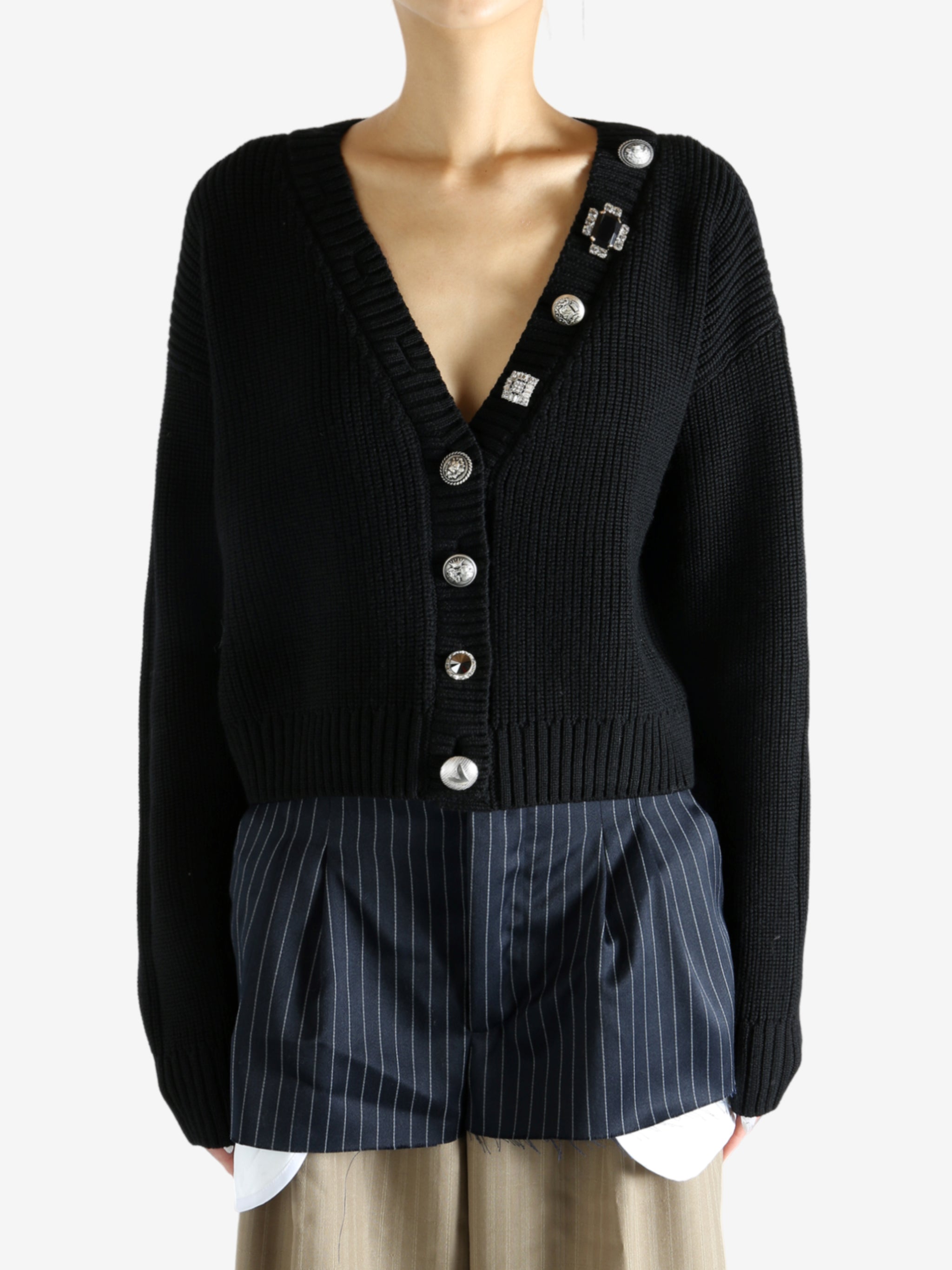 Black cardigan worn by a person, showing the cardigan’s fit