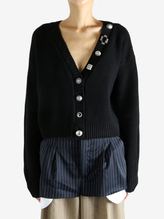 Black cardigan worn by a person, showing the cardigan’s fit