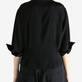 Black shirts worn by a person, showing the shirts fit