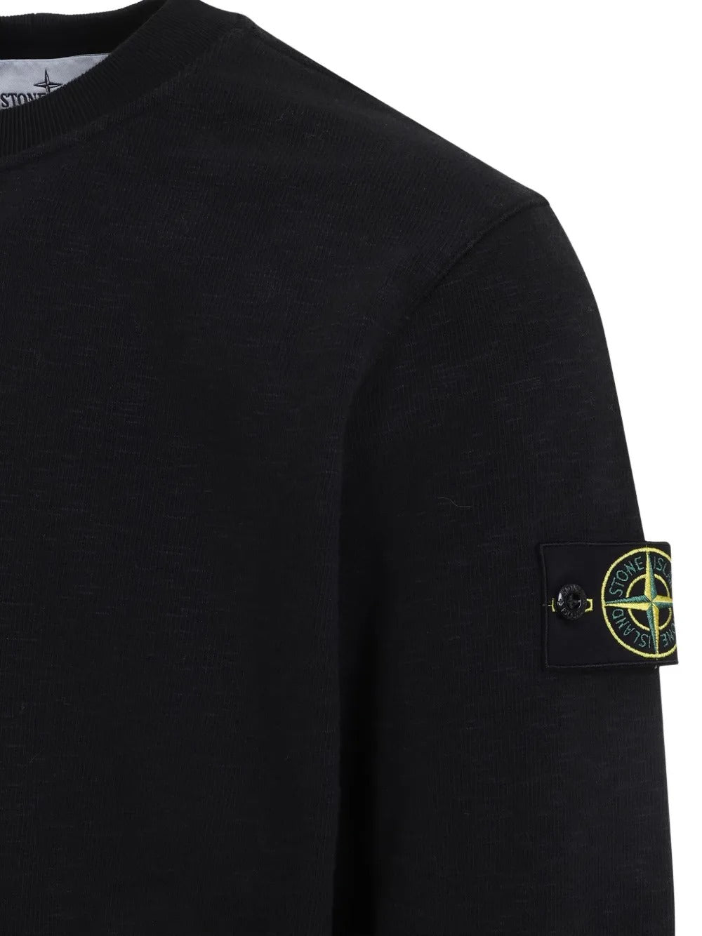 Close up of the black sweatshirt, showing texture of the cotton fabric
