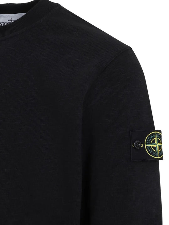 Close up of the black sweatshirt, showing texture of the cotton fabric