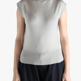 White top worn by a person, showing the top's fit