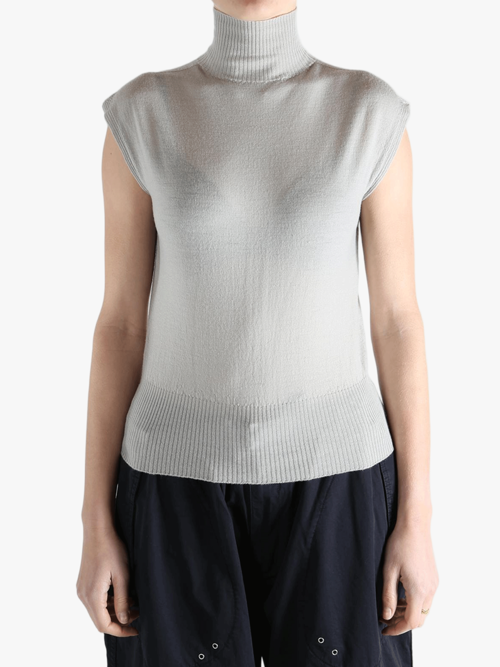 White top worn by a person, showing the top's fit