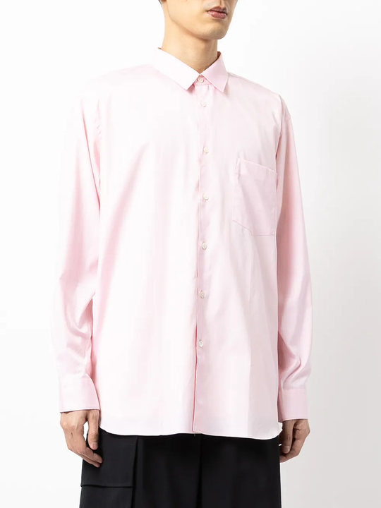 Pink shirt worn by a person, showing the shirt fit