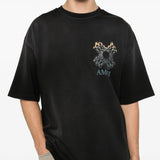 Black t-shirt worn by a person, showing the shirt' fit