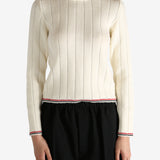 White knitwear worn by a person, showing the knitwear's fit