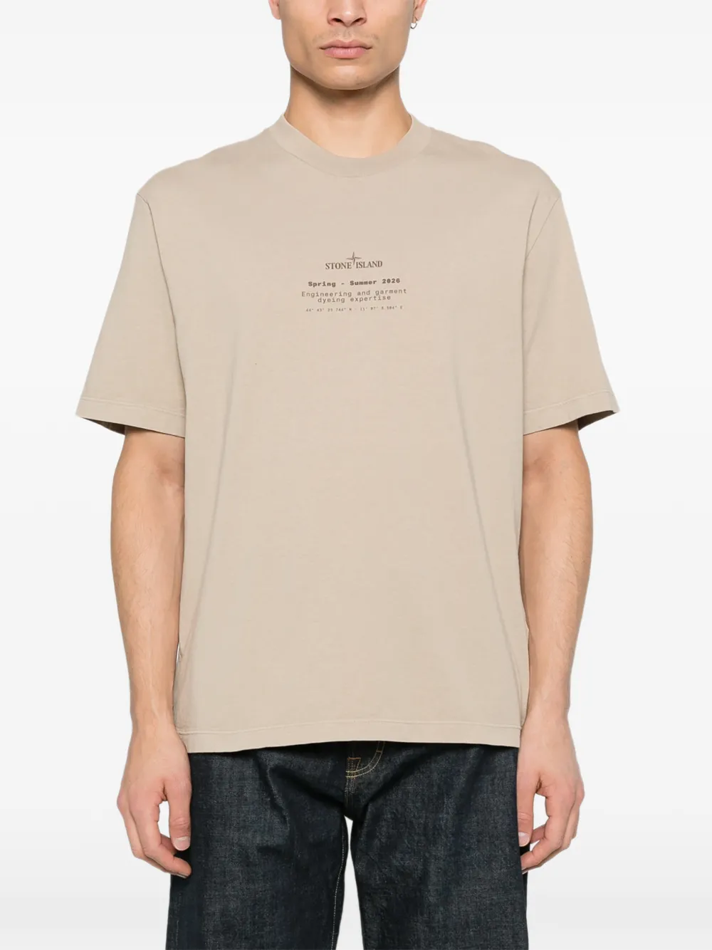 Tan t-shirt worn by a person, showing the tan t-shirt's fit