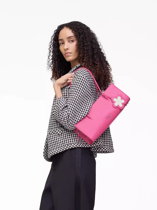 Pink bag worn by a person, showing the bag's fit