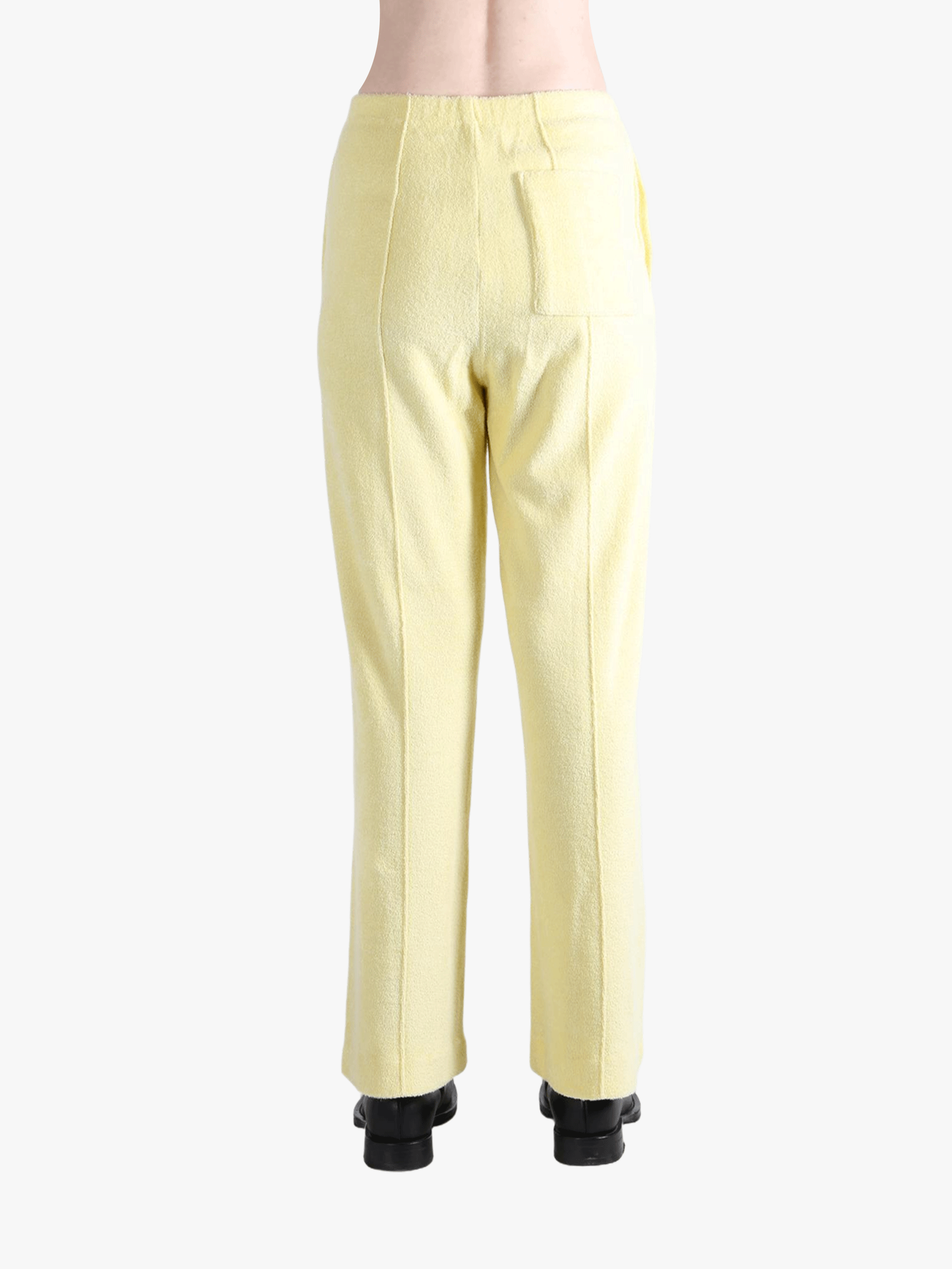 Yellow pants worn by a person, showing the pants' fit