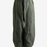 Green pants worn by a person, showing the pants' fit