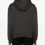 Grey hoodie worn by a person, showing the hoodie's fit