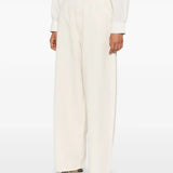 White pants worn by a person, showing the pants' fit