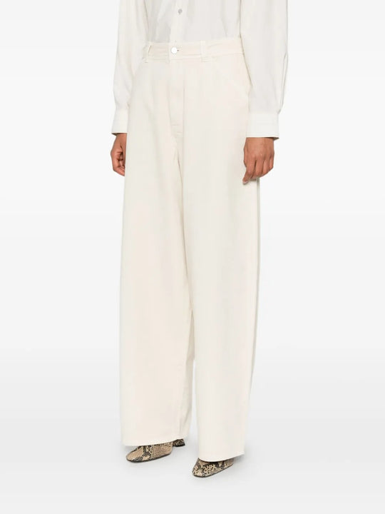 White pants worn by a person, showing the pants' fit