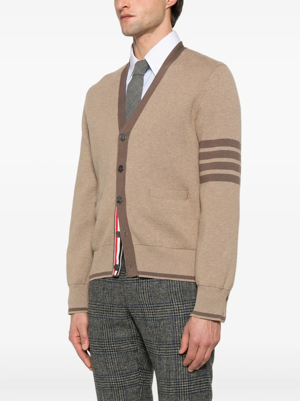 Brown knitwear worn by a person, showing the knitwear's fit
