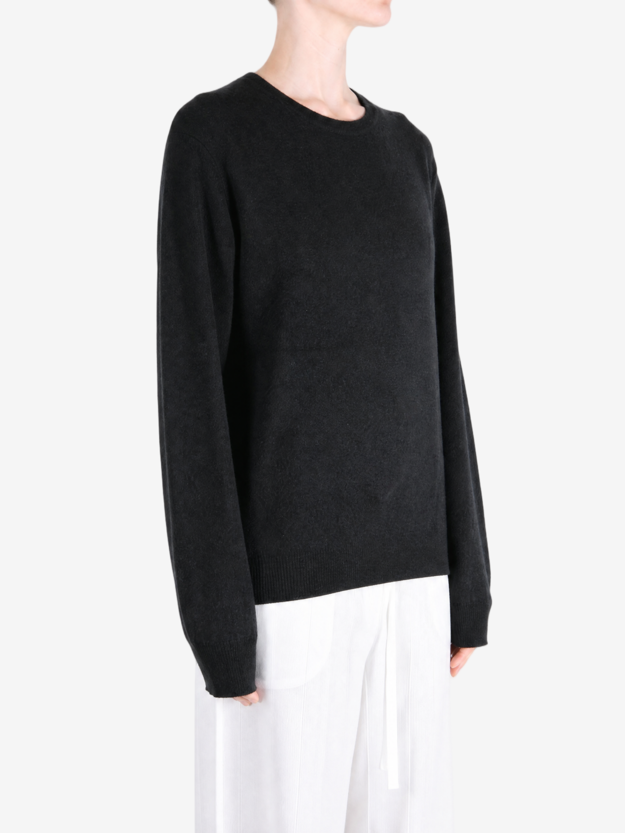Black hoodie worn by a person, showing the hoodie fit