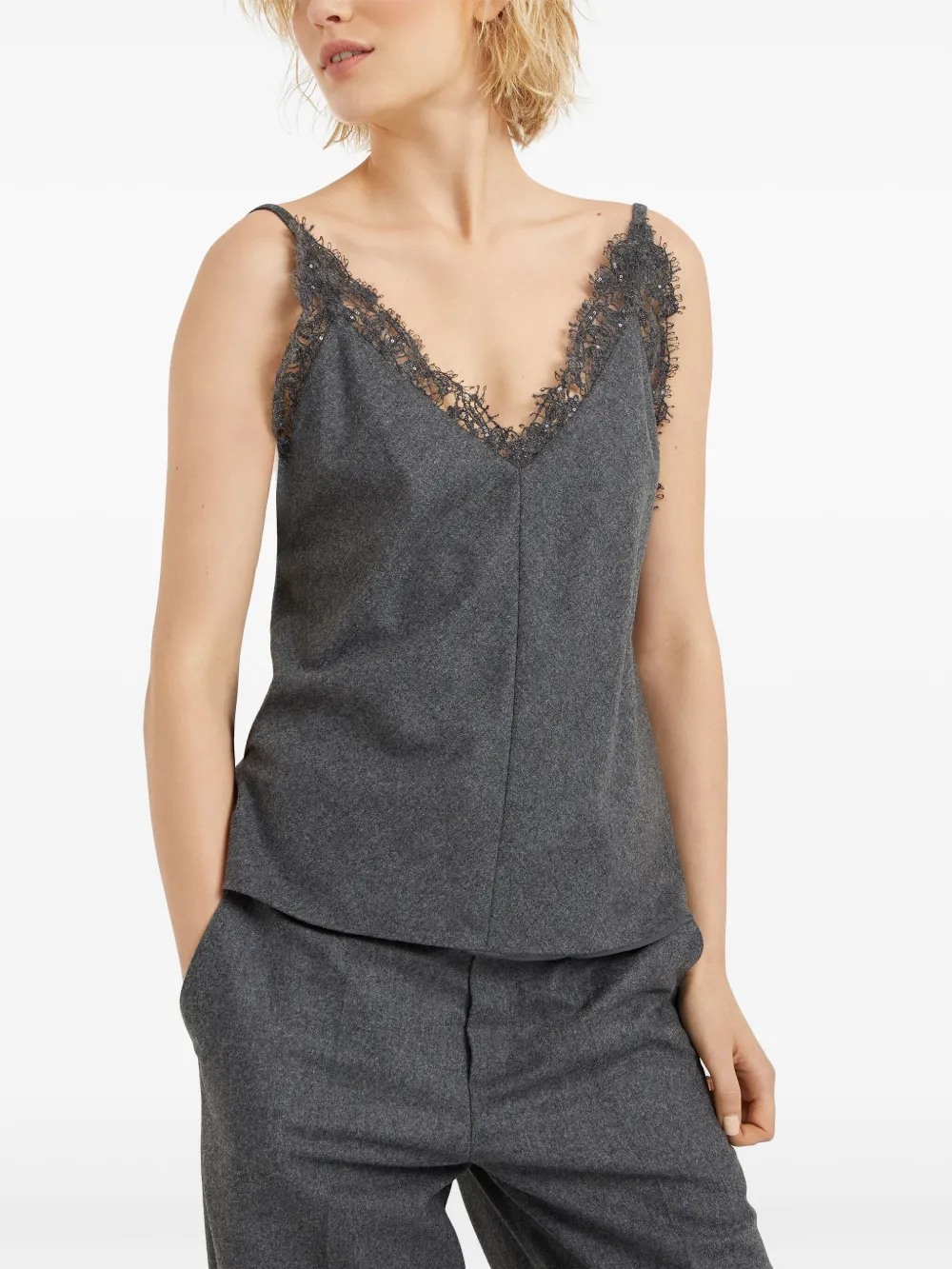 Grey tops worn by a person, showing the tops fit