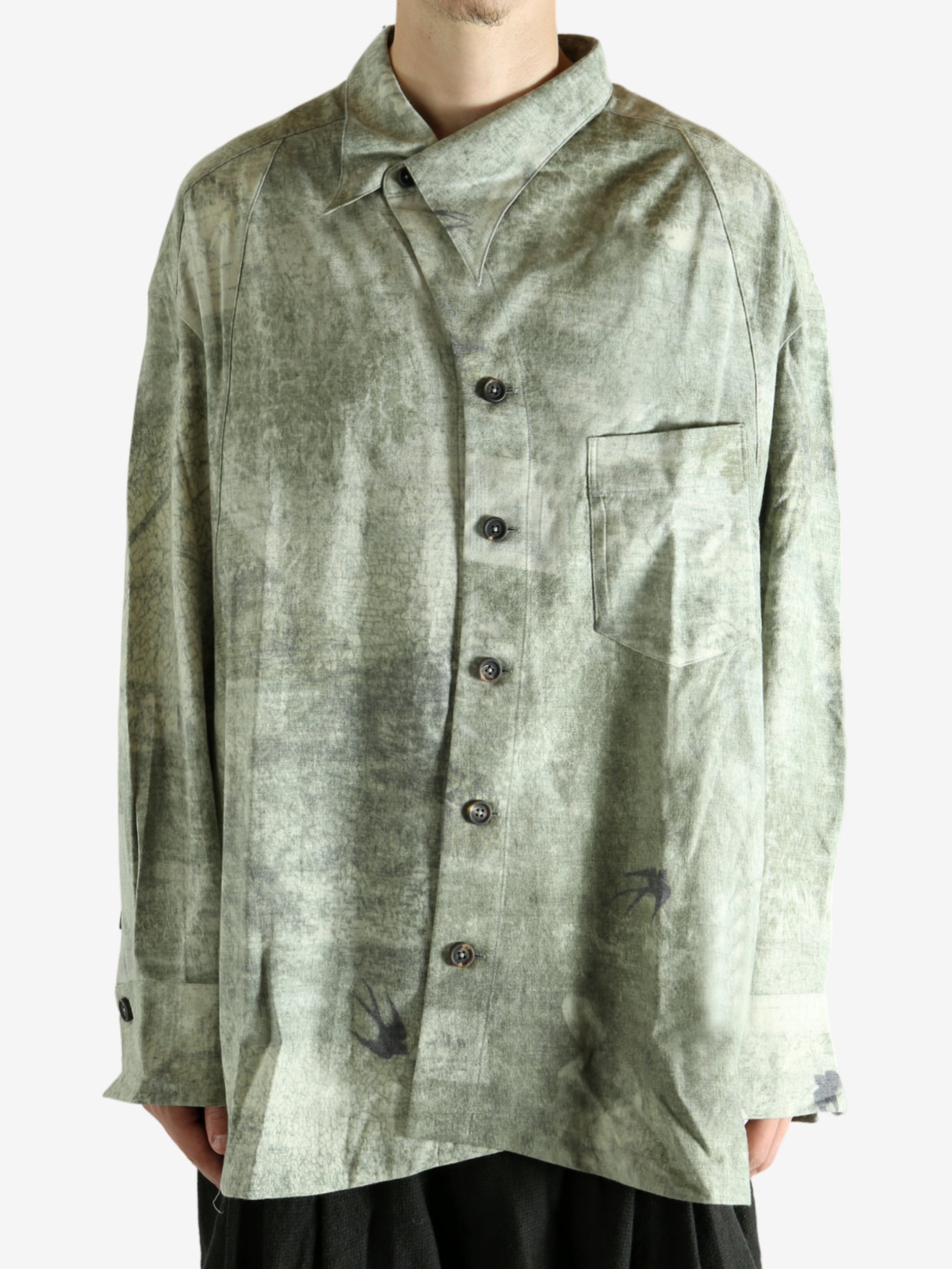 Green shirt worn by a person, showing the shirt's fit